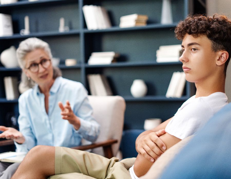 Counselor discussing with young adult.