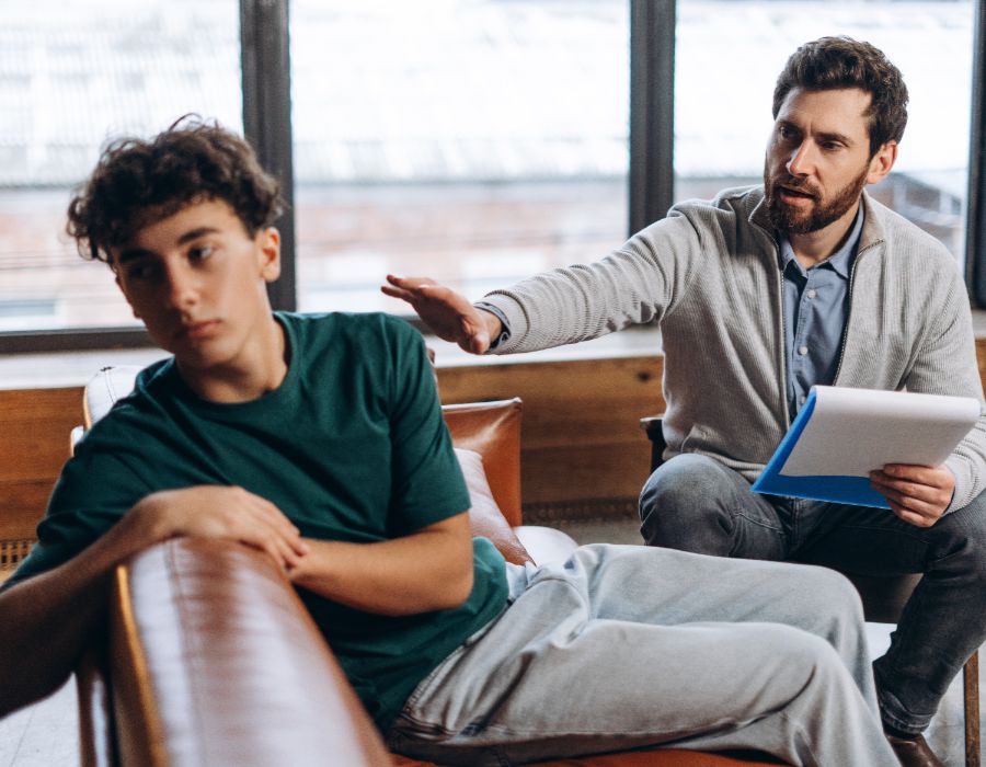 Counselor talking to a teenager.