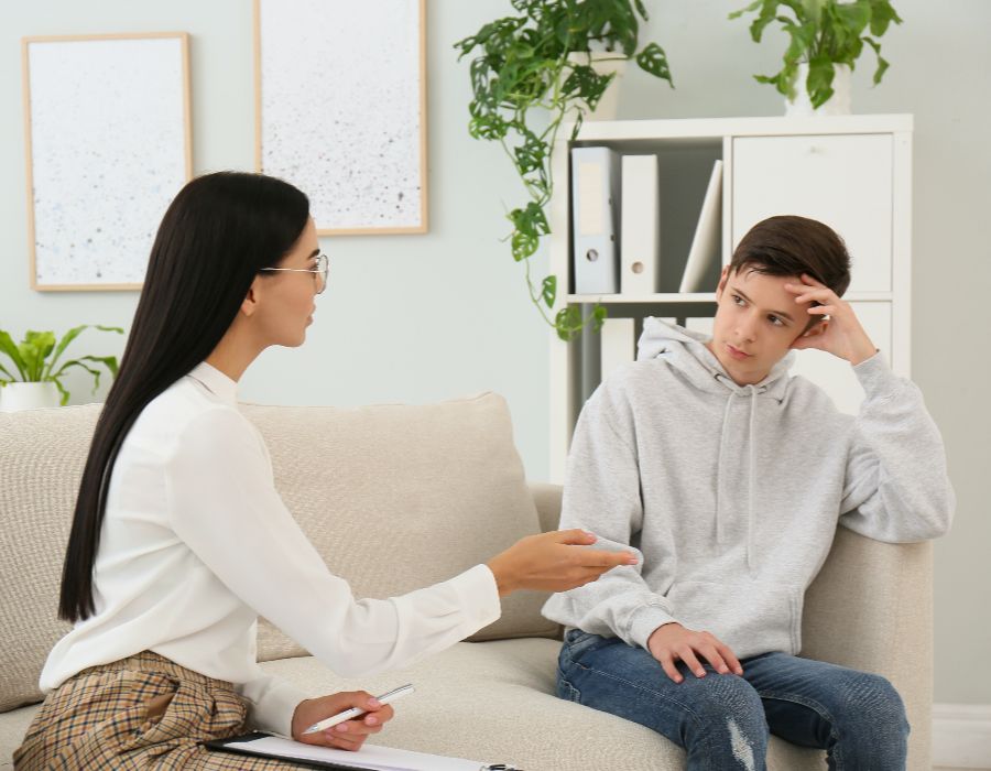 Counselor talking to a teenager.