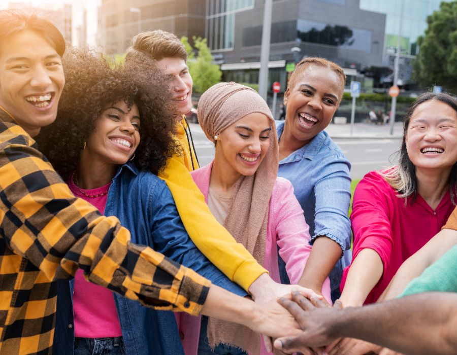 Diverse group celebrating together outdoors.