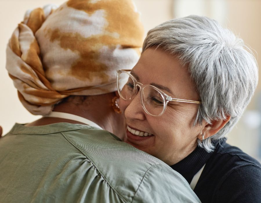 Two women sharing a warm embrace.