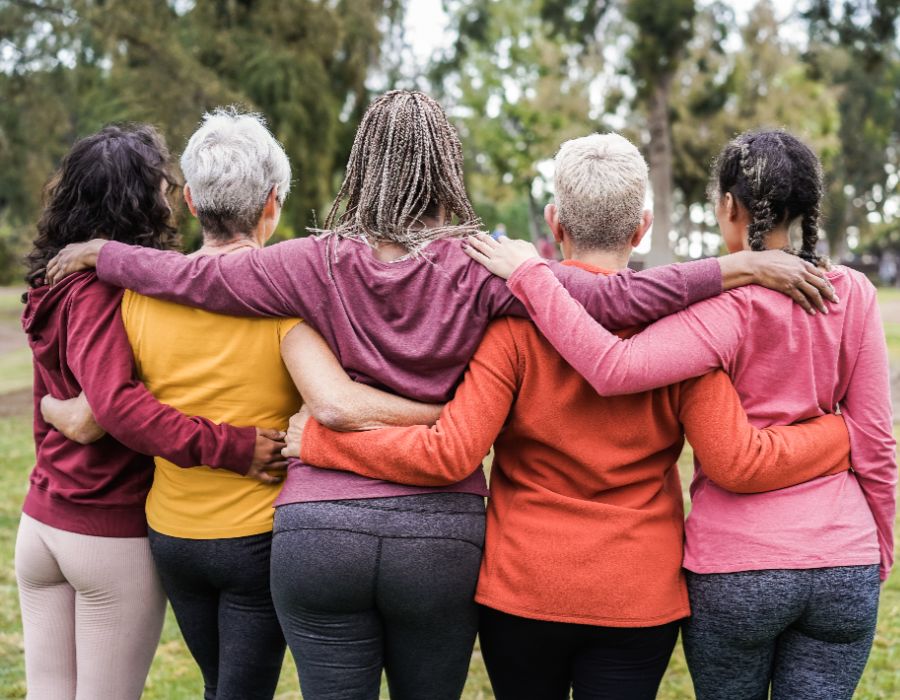 Group of women embracing outdoors.