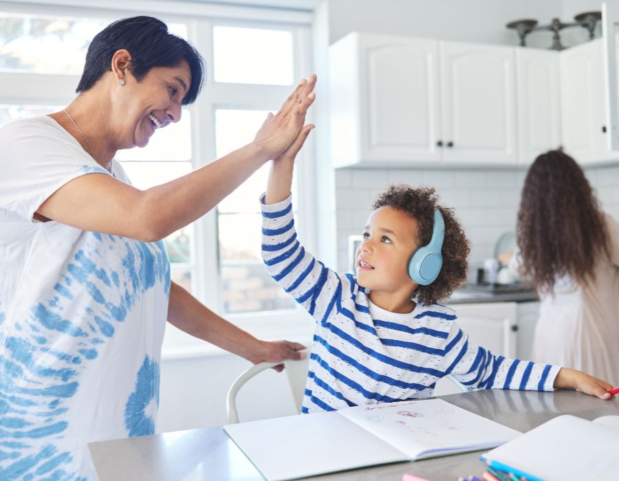 Child and adult sharing a high-five