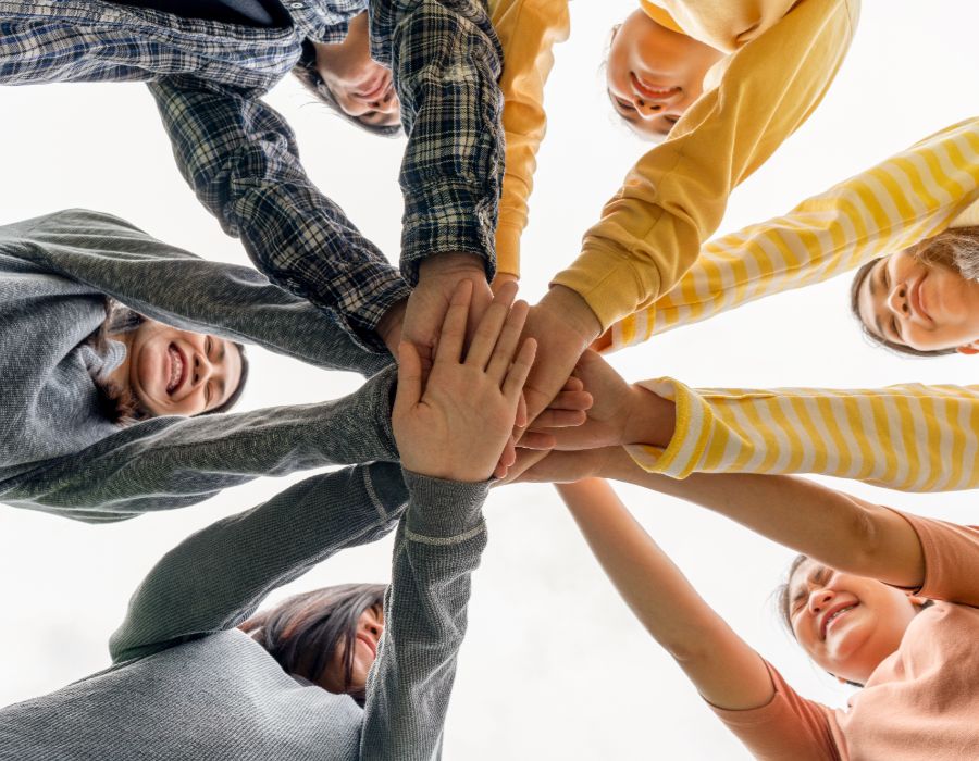 Group of hands joining together.