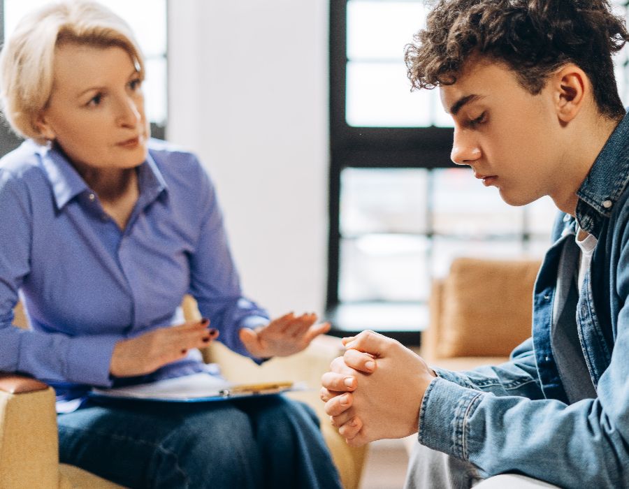 Counselor discussing with a teenager.
