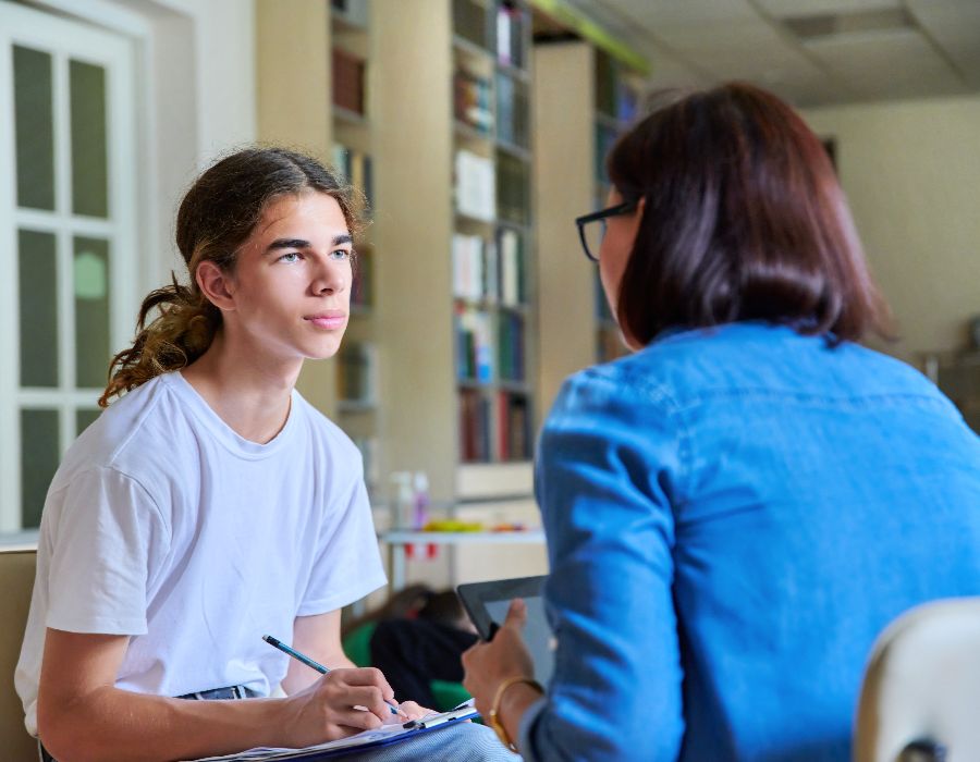 Why Action Based Anxiety Coaching is the Kickstart You Need 1 Teen and adult engaged in conversation