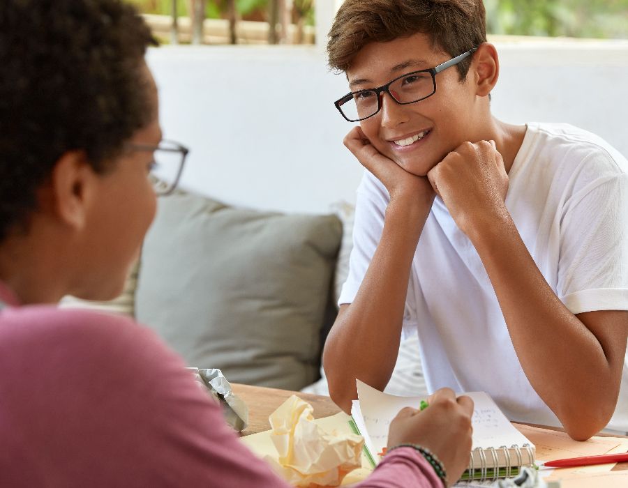 Two teens engaged in conversation.